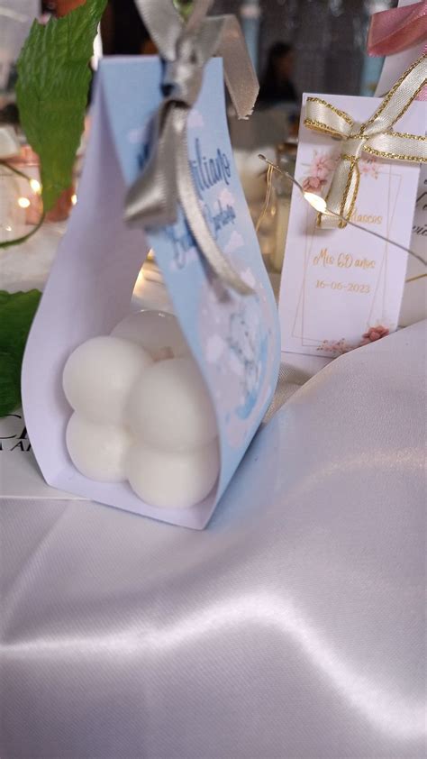 A Small Bag With Two White Balls In It Sitting On A Table Next To Some