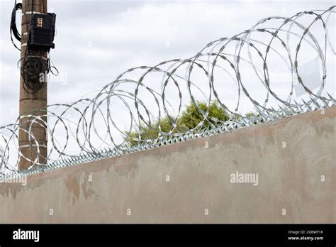 Installation Of Concertina Wire Barriers With Brackets Fence Crossed