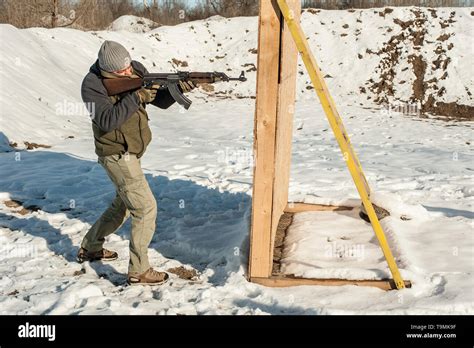 Instructor Demonstrate Body Position Of Combat Rifle Shooting At Winter