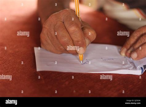 Closeup Hands Of An Old Man Writing Down And Drawing A Route On White