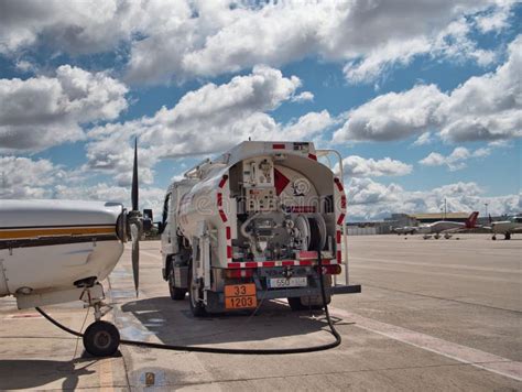 Fuel Tanker Truck Refueling an Airplane Editorial Photography - Image ...