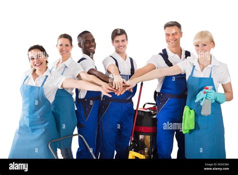 Group Of Happy Janitors Stacking Hands Isolated On White Background