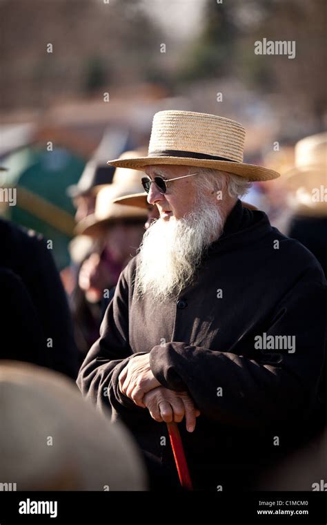 Amish Man Bids On Farm Equipment During The Annual Mud Sale To Support