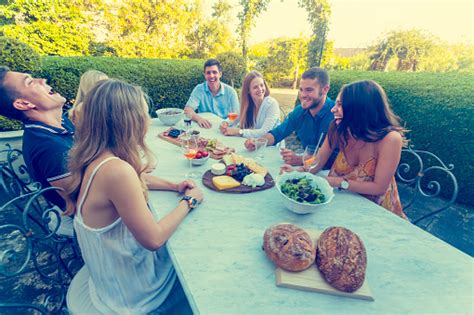 Group Of Young People Eating Outdoors Stock Photo & More Pictures of 20 ...