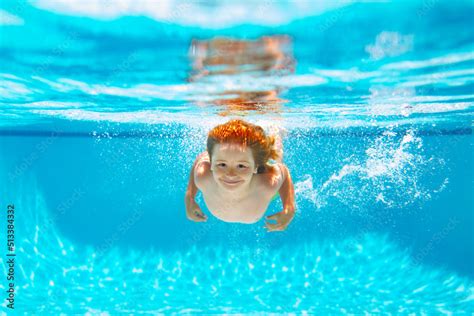 Child underwater swim in the swimming pool. Cute kid boy swimming in ...