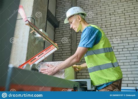 Experienced Worker Packing Goods On A Packaging Machine Stock Image