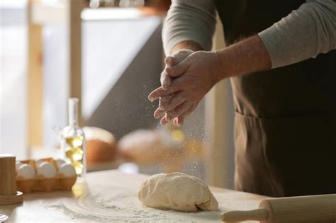 Premium Photo Man Making Dough In Kitchen