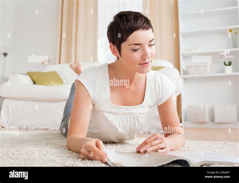 Cute Brunette Reading A Magazine Stock Photo Alamy