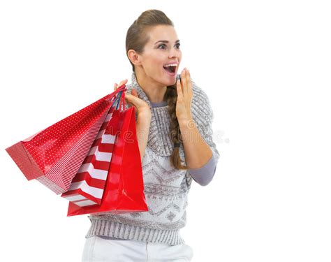 Surprised Woman In Sweater With Shopping Bags Looking On Copy Space