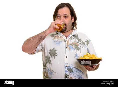 Fat Caucasian Man Drinking Beer And Holding Bowl Of Chips Ready Stock