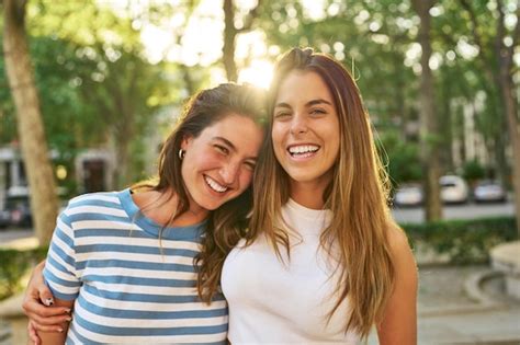 premium photo  friends smiling happily   park