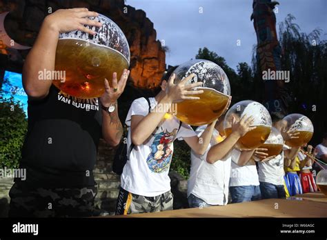 Participates use fish tanks to drink beer during a beer drinking ...