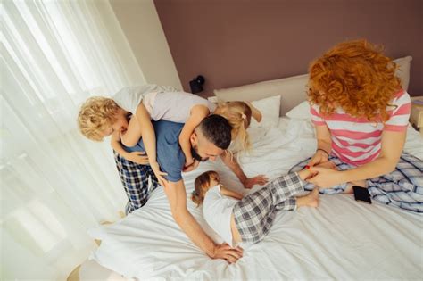 Premium Photo | Delighted happy children playing with their parents