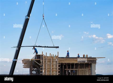 Self Propelled Crane Unloads Building Materials In An Erected Apartment