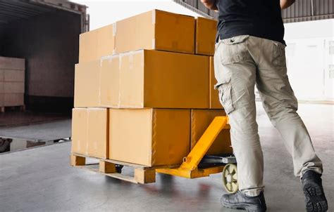 Premium Photo Workers Courier Unloading Packaging Boxes On Pallet