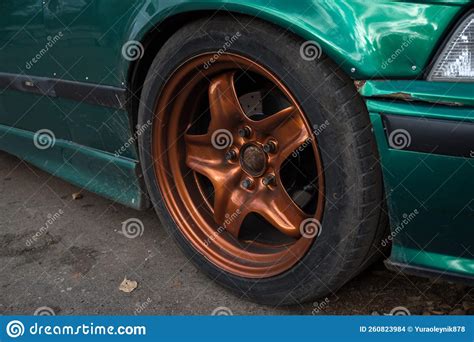 Tuned Green Car On Metallic Burnt Orange Rims Dirty In Autumn Stock