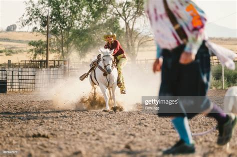 Young Woman Competing In Rodeo Goat Roping High-Res Stock Photo - Getty ...