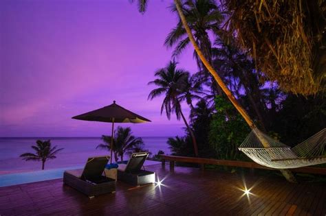 Yasawa Island Resort & Spa, Fiji Resort Accommodation. Enjoying a sunset on the deck of a ...