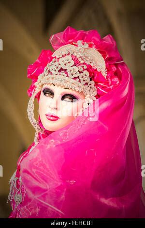 Close Up Of A Venetian Woman Wearing A Golden Mask And A Blue And Green