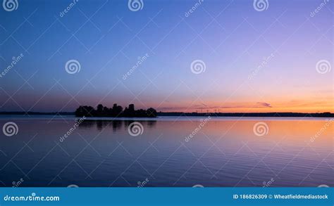 Lake and sky at sunrise stock image. Image of scenic - 186826309