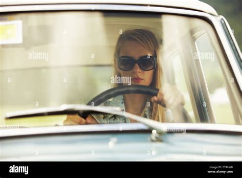 Young woman driving vintage car Stock Photo - Alamy