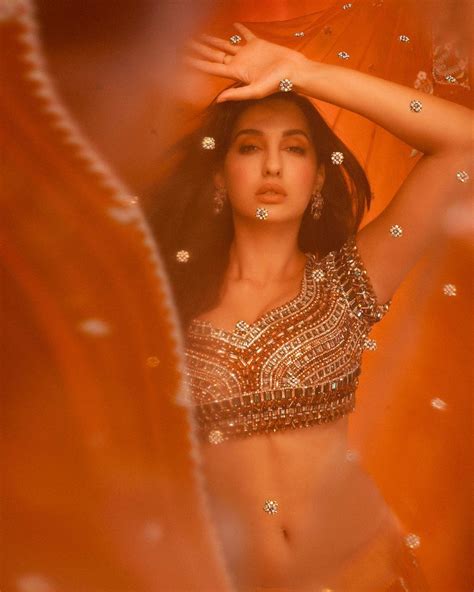 Nora Fatehi Looks Sensuous In Orange Lehenga And Embellished Silver Blouse See Her Sexy Pictures