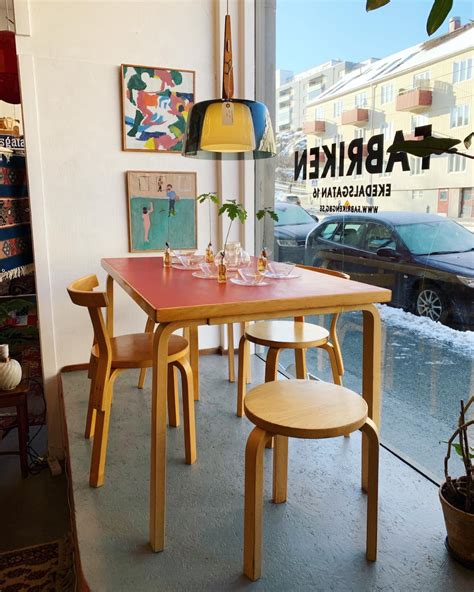 A Table And Chairs In Front Of A Window With An Advertisement For