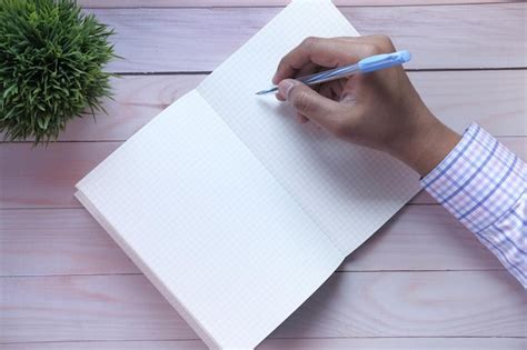 premium photo close   businessman hand writing  notepad