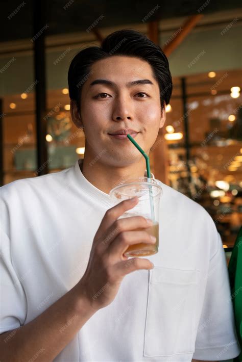 Free Photo Front View Man Drinking Iced Coffee