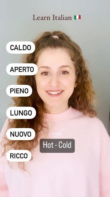 A Woman Wearing A Pink Sweater With The Words Hot Cold Written On Her