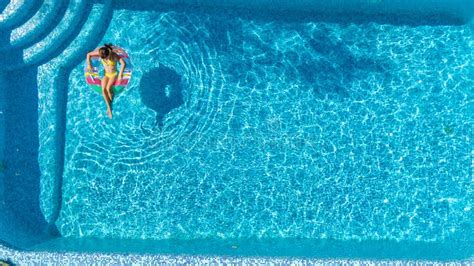 Aerial View Of Girl In Swimming Pool From Above Kid Swim On Inflatable