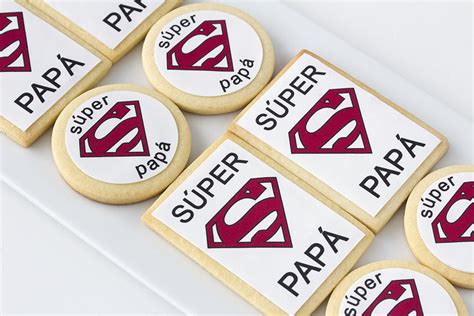 Some Cookies With Superman Logos On Them