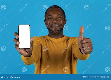 Happy African American Man Showing Cell Phone And Thumb Up Stock Photo