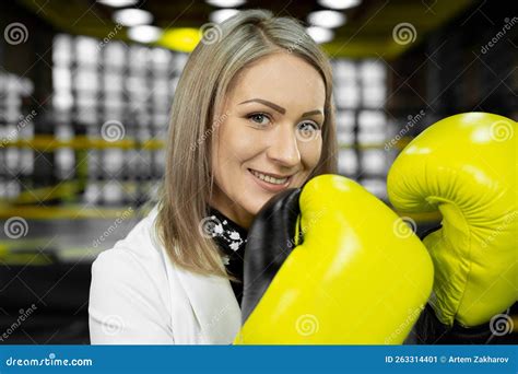 Stylish Businesswoman in Yellow Boxing Gloves on the Background of a ...