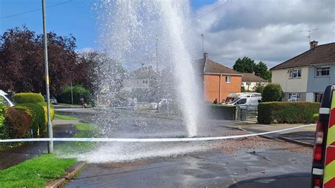 dramatic pictures show water spewing  residential street