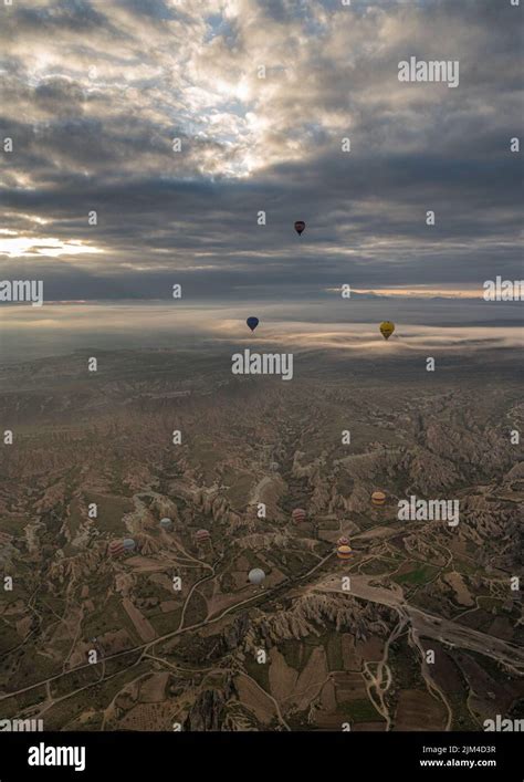 A Vertical Drone View Of Hot Air Balloons Above The Goreme National