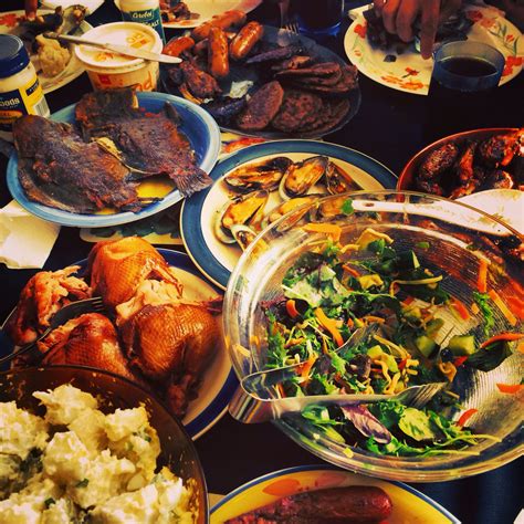 a table filled with plates and bowls full of different types of food