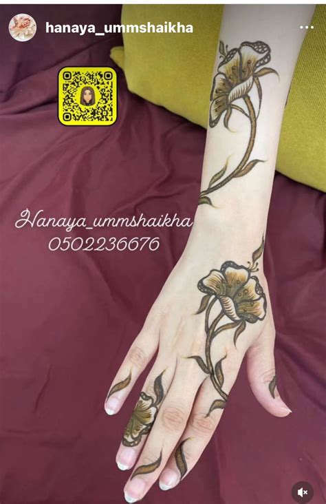 A Woman S Hand With Flowers On It And The Words Henya Umshakiha