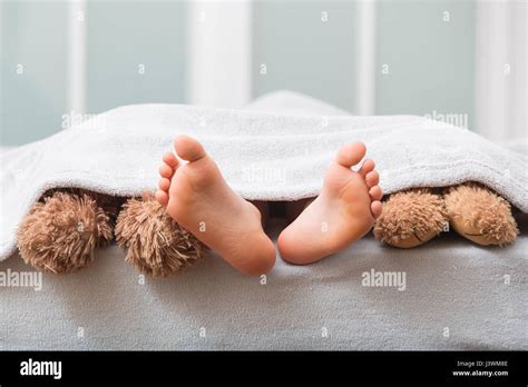 Sleeping couple barefoot lying bed hi-res stock photography and images - Alamy