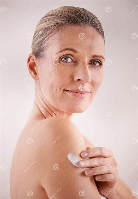 Keeping Her Skin Soft Studio Shot Of A Beautiful Mature Woman Applying