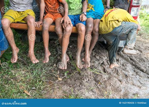 Dirty Feet With Mud Of Children Sitting On A Pickup Closeup Stock