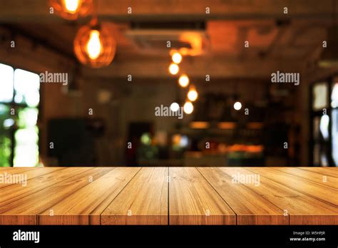 Empty Wooden Table Top With Blurred Coffee Shop Or Restaurant Interior