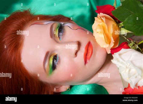 Portrait Of Beautiful Red Haired Girl With Flowers And Bright Makeup