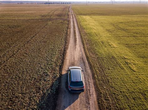 Premium Photo Aerial View Of Car Driving By Straight Ground Road