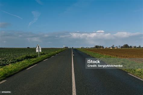 Asphalt Road Passing Through The Fields In The Region Of Normandy