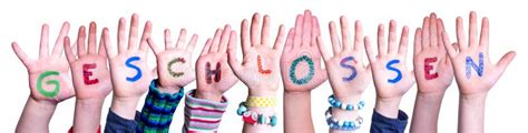 children hands building word geschlossen means closed isolated