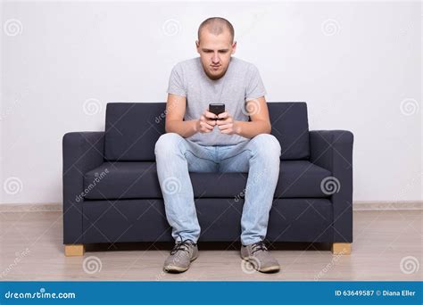 Handsome Man Sitting On Sofa With Mobile Phone Stock Image Image Of