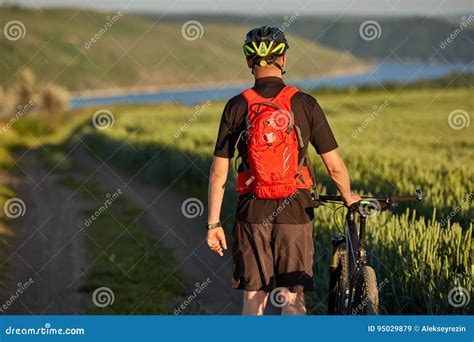 Rear View Of The Young Cyclist With Mountain Bicyclist In The Summer