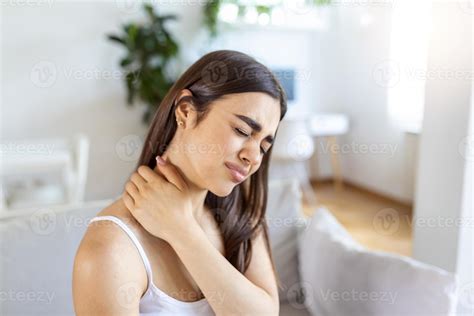 Tired woman massaging stiff sore neck, tensed muscles fatigued from