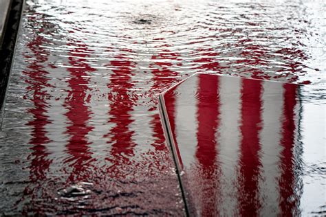 Us Flag Reflected In Water At Hennepin County Government Center